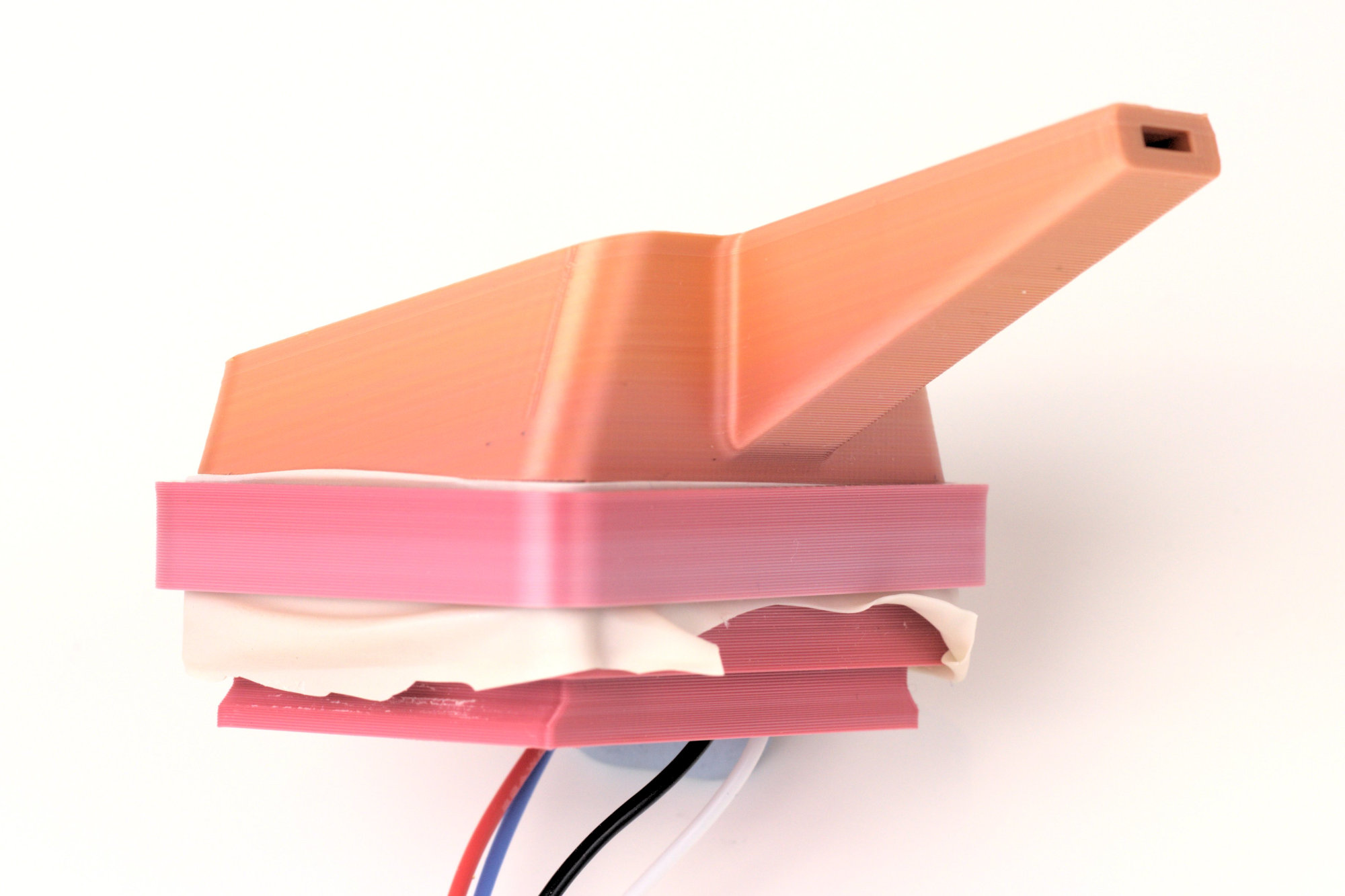 The 3D printed prototype in orange and pink - the balloon membrane is now held in place with a plastic ring instead of taped on